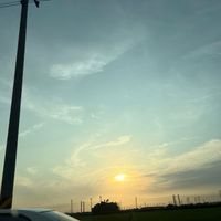 可能是地平線、風車、雲、霧、道路和暮光的圖像