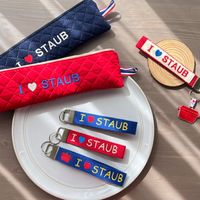 可能是顯示的文字是「 STAUB STAUB IOSTAUB I STAUB ÖLISTAUB I STAUB ISTAUB I STAUB I STAUB ယ 」的圖像