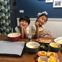 可能是 3 個人、小孩、食物和室內的圖像