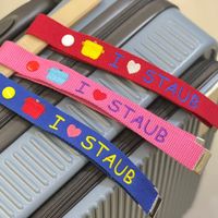 可能是紅心、手提箱和顯示的文字是「 PIOSTAUB I I IOSTAUB STAUB STAUB STAUB STAUB 」的圖像